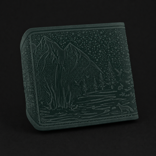 Green wallet with mountain and fox design on a black background