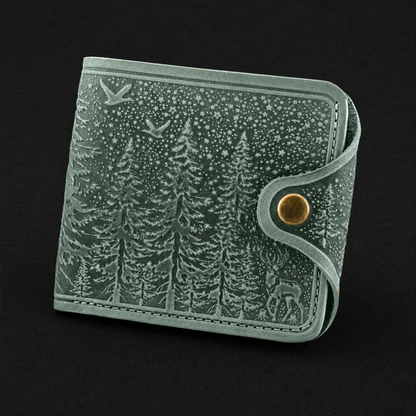 Gray leather wallet with forest design on a black background