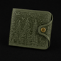 Green wallet with forest design on a black background