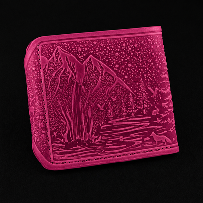 Pink wallet with mountain and lake design on a black background
