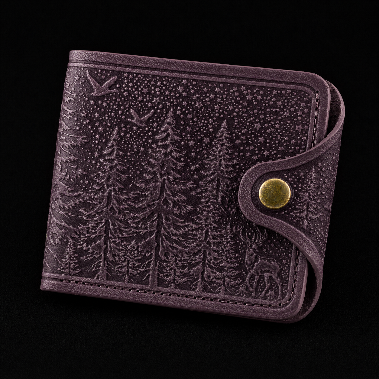 Leather wallet with forest design and gold button on a black background