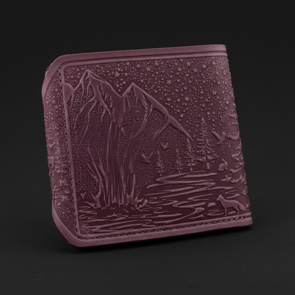 Purple embossed wallet with nature design on a black background