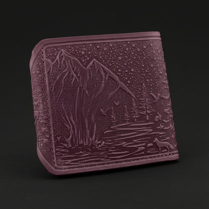 Purple embossed wallet with nature design on a black background