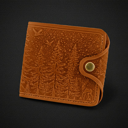 Brown leather wallet with embossed design on a black background