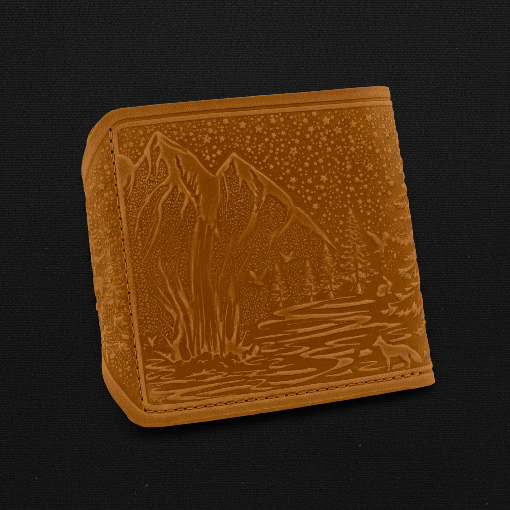 Brown leather wallet with mountain design on a black background