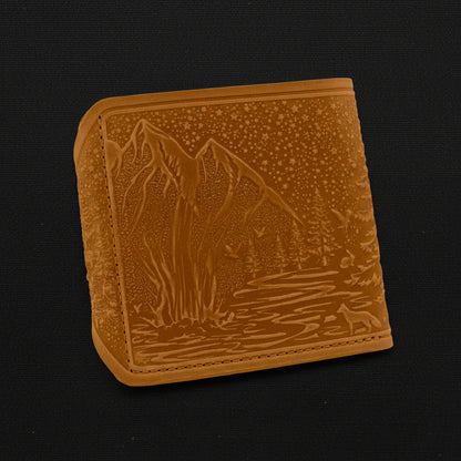 Brown leather wallet with mountain design on a black background