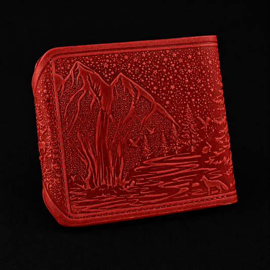 Red embossed wallet with mountain and wolf design on a black background