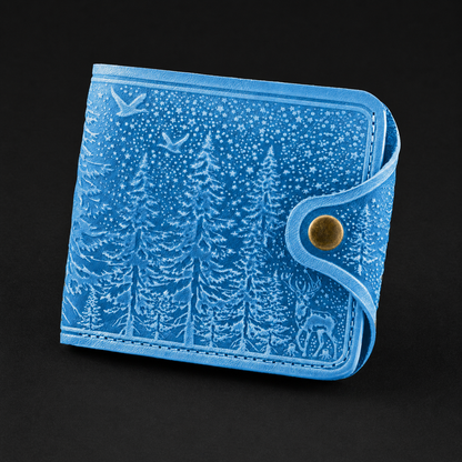 Blue wallet with forest design on a black background