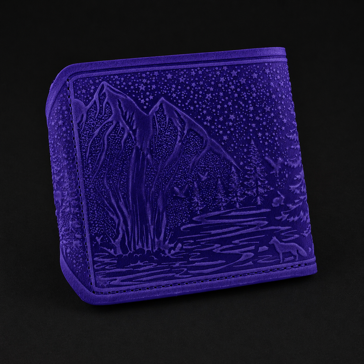 Purple embossed wallet with nature design on a black background