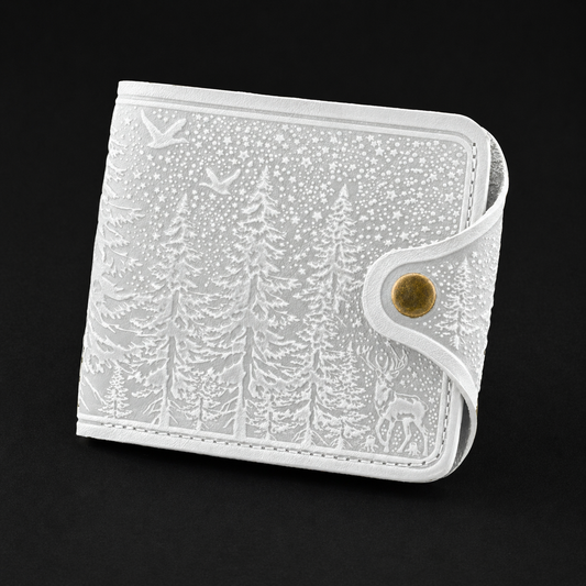 White wallet with nature-themed design on a black background